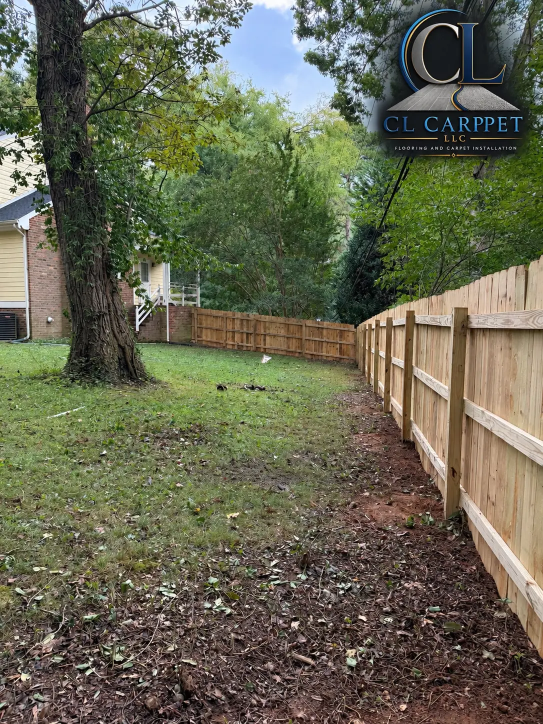 New wood privacy fence bordering a residential backyard