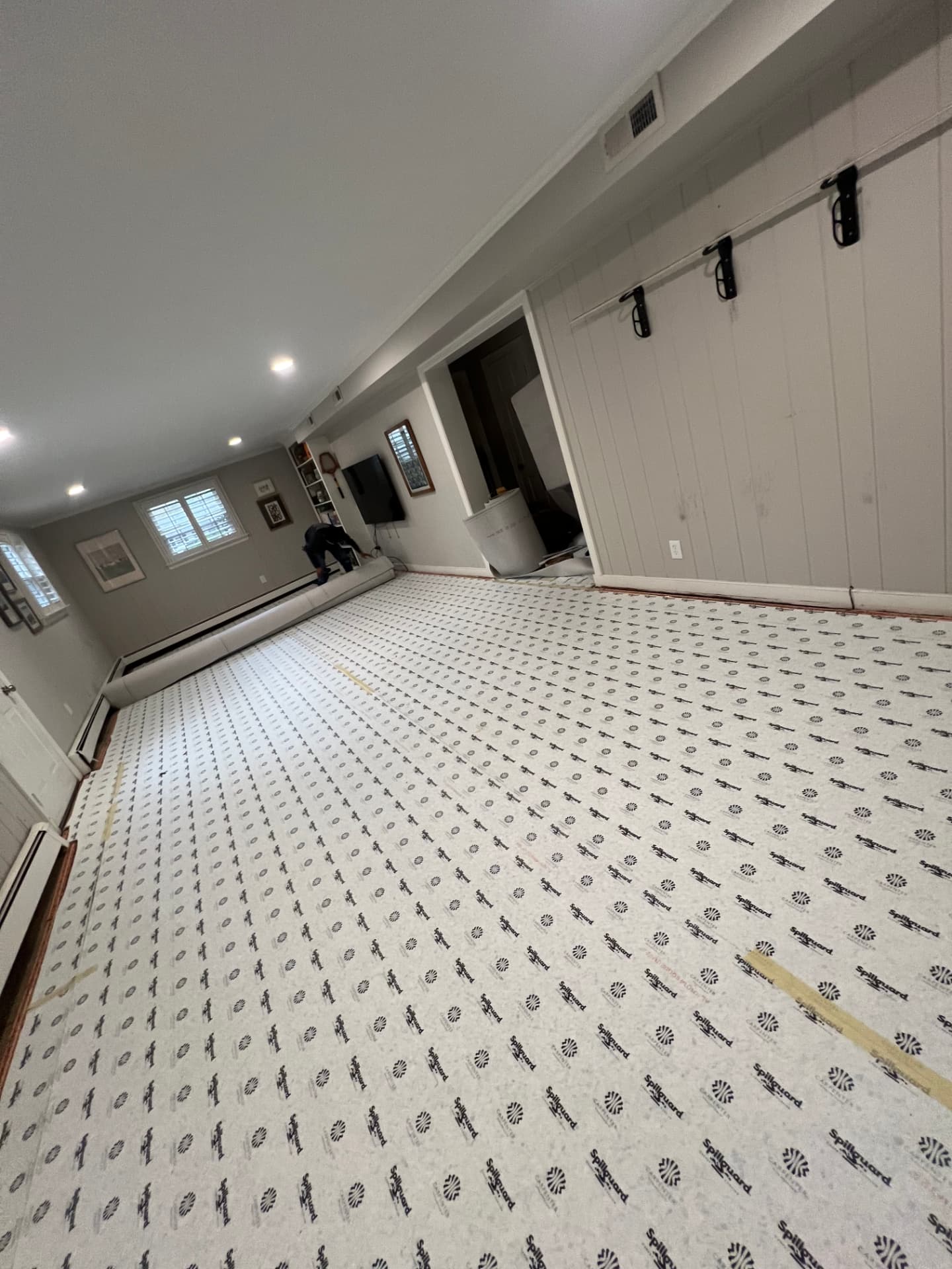 Carpet padding laid across a basement living area
