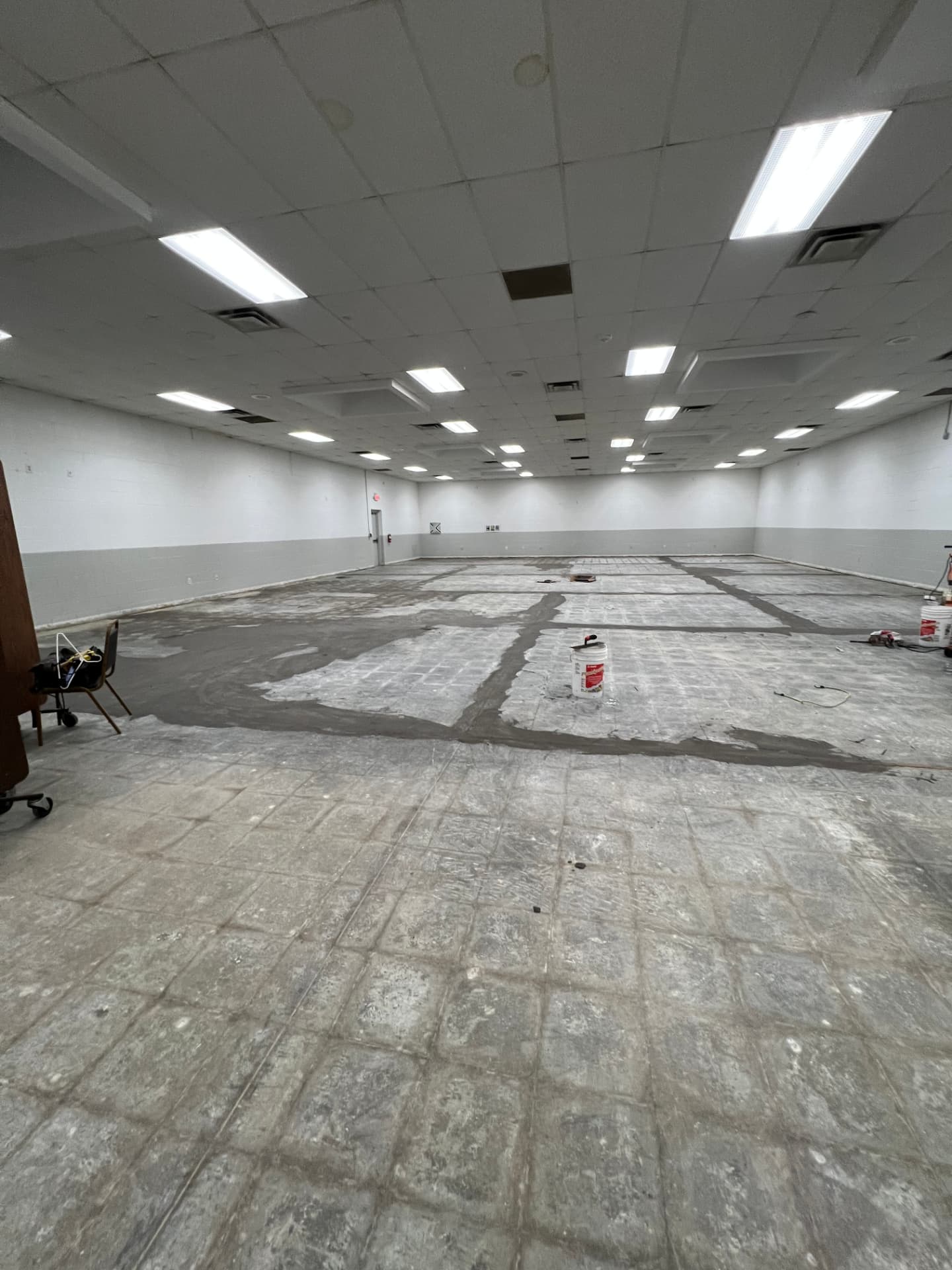 Large commercial room with old flooring removed and subfloor patched